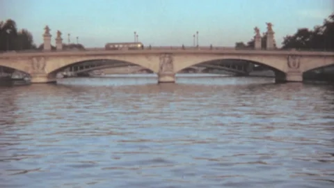Paris - 1973: boat passengers point of view tour on seine river by old bridge Stock Footage 231162073