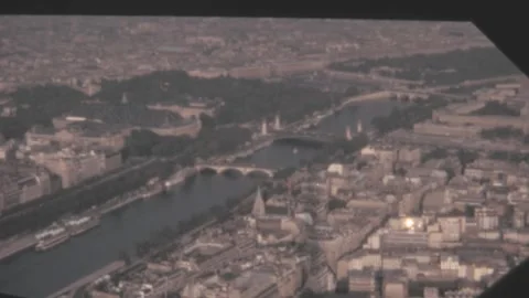 Paris - 1973: bridge over Seine river and city buildings view from Eiffel tower Stock Footage 231161176
