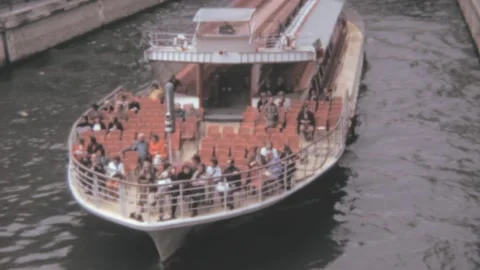 Paris - 1973: passengers sit on sightseeing cruise ship on Seine river tour Stock Footage 231162402