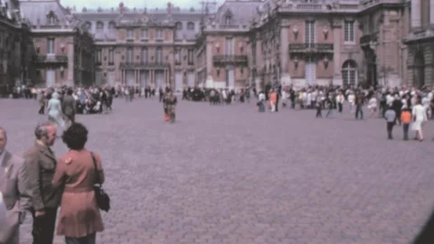 Paris - 1975: groups of visitors by Versailles palace historical landmark Stock Footage 220938737