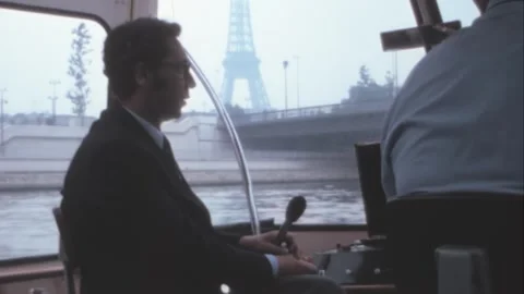 Paris - 1975: Guide with suit waits to talk on a sightseeing tour on Seine River Stock Footage 282708976