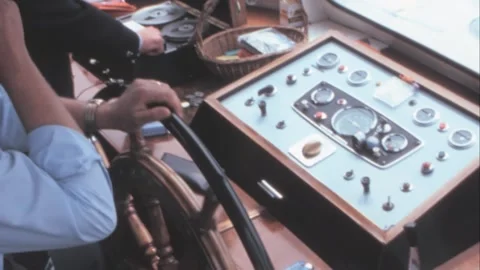 Paris - 1975: Ship Captain adjusts controls on bridge of a ship on Seine River Stock Footage 282709113