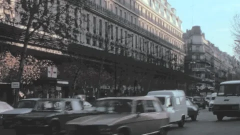 Paris - 1979: vehicles start drive at junction in city center by old buildings Stock Footage 209618090