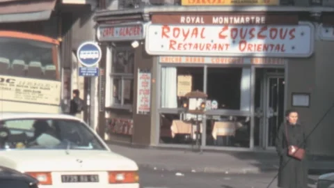 Paris - 1981: Traffic in front of restaurant Royal Cous Cous Stock Footage 246477368