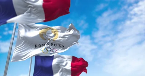 Paris 24 Olympic flag waving in the wind between two French flags Stock Footage 164548935