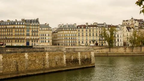 Paris architecture lining Seine river, classic Haussmann buildings reflecti.. Stock Photos