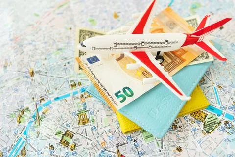 Paris city map composition with euro banknotes, dollars, passports and a to.. Stock-Fotos