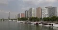 Paris City Skyline with Eiffel Tower and Futuristic Buildings on Seine River Day 4k or 4k+ Resolution