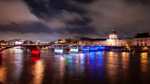 Paris Cityscape at Night with a Glowing Bridge and River Movement Stock Footage 331104657