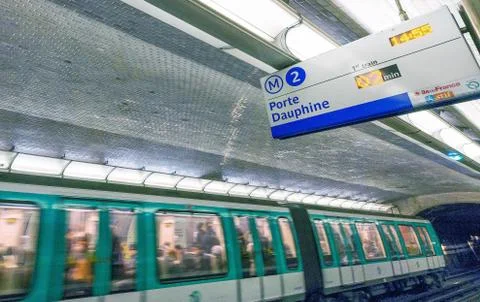 PARIS - DECEMBER 2012: Train moves inside a subway station. Paris Metro is th Stock Photos