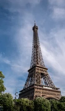 Paris Eiffel tower dominant background wispy clouds Stock Photos