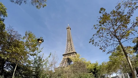 Paris Eiffel Tower extreme wide shot through trees Stock Footage 96216055