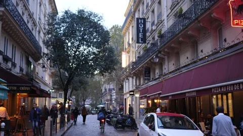 Paris evening facades lights and people walk on cozy narrow street of Latin quar Stock Footage 164515216