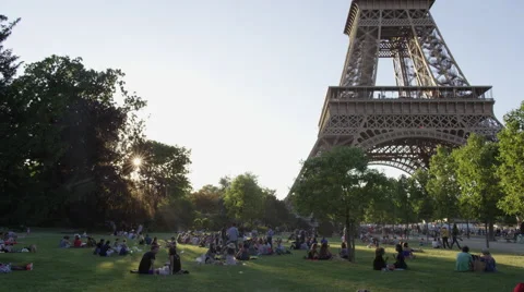 Paris' famous Eiffel Tower - Crowd having picnic at the base Stock Footage 65318272
