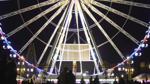 Paris ferris wheel slowly rotating night, people visit amusement park, landmark Stock Footage 86600930