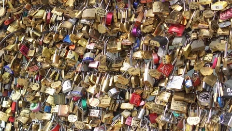 PARIS, FRANCE- CIRCA August 2017: Bridge fence full of locks. Lovers Romantic Stock Footage