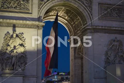 Paris, France, June 18 2018: Focus on french flag hanging down Arc de Triomphe Stock Photos