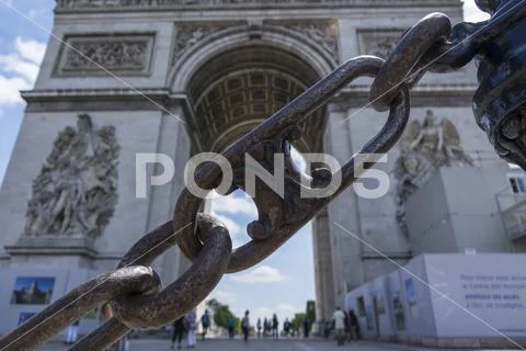 Paris, France, June 20, 2018: Focus on metal chain in front of Arc de Triomph Stock Photos