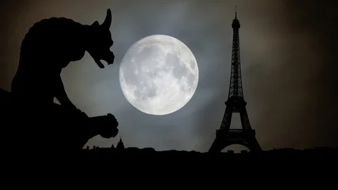Paris: Gargoyle looks the Eiffel Tower and City Skyline by Night with Full Moon Stock Footage 102644611