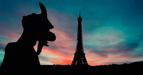 Paris Gargoyle Looks Eiffel Tower And City Skyline France Red Blue Sky at Dusk Stock Footage 151293569