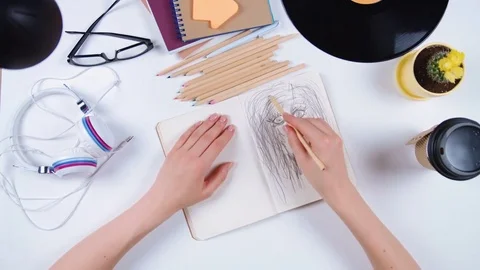 Paris - May 19, 2016: Close-up of a woman's hand drawing a pencil in a notebook Stock Footage 77258629