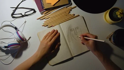 Paris - May 19, 2016:Close-up of a woman's hand drawing a pencil in a notebook Stock Footage 77261624