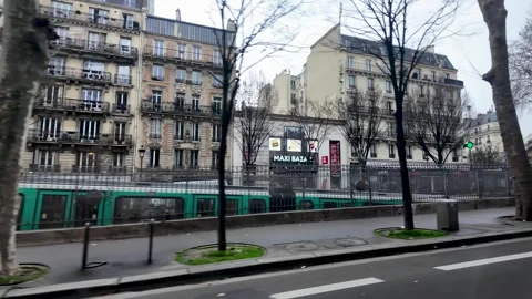 A Paris Metro RATP train passes by buildings as seen from a POV driving Stock Footage 330861026