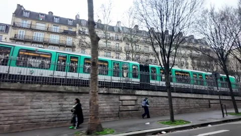 A Paris Metro RATP train is seen from a POV driving past with an urban Stock Footage 330859890