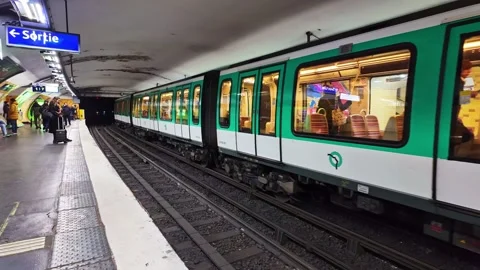 Paris Metro train arriving underground station, commuters on platform, urban Stock Footage 302947215