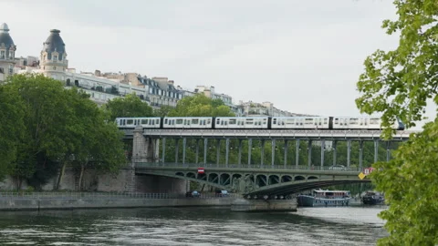 Paris Metro Train Crossing the Pont de Bir-Hakeim Over the Seine River Framed by Stock Footage 338326727