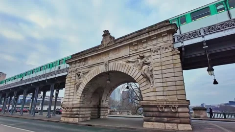 Paris Metro train passing on an elevated bridge Pont de Bir-Hakeim, Paris Stock Footage 305587425