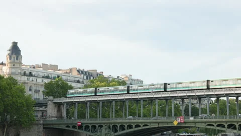 Paris Metro Train Speeds Along the Upper Viaduct of Pont de Bir-Hakeim Against a Stock Footage 338326769