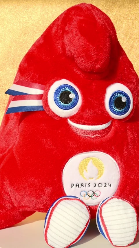 Paris Olympic Games 2024 mascot the Phryges rotating on gold background Stock Footage 262425697