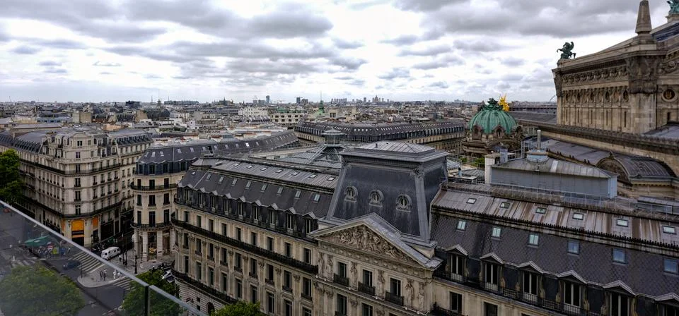 Paris rooftops view with cloudy sky Stock Photos