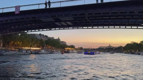 Paris Seine River at Dusk With Bridge, Boats and Riverside Lights at Sunset Stock Footage 336141289
