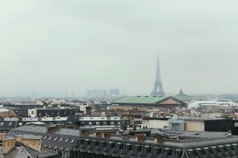 Paris skyline with rooftops and the Eiffel tower on a foggy day. Paris symbol 库存照片