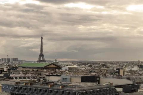 Paris skyline with rooftops and the Eiffel tower on a cloudy day. Paris symbol 库存照片