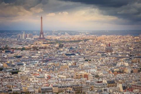 Paris skyline at sunset with Eiffel Tower above parisien roofs, Paris, France Stock Photos