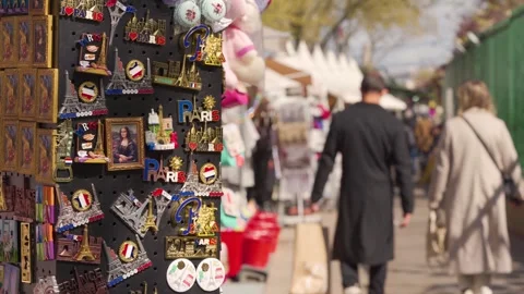 Paris Souvenir Stall Displaying Eiffel Tower Magnets and Trinkets along Busy Stock Footage 340180892