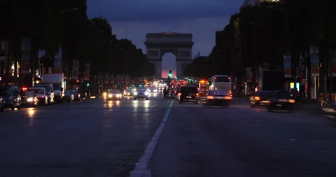 Paris street at night with the Arc de Triomphe in Paris, France time lapse Stock Footage 240840142