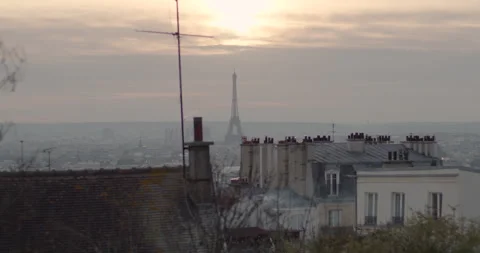 Paris sunset: Eiffel Tower view from Montmartre. Orange hues blend with the Stock Footage 257795496