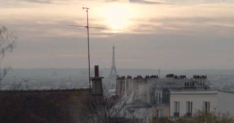 Paris sunset: Eiffel Tower view from Montmartre. Orange hues blend with the Stock Footage 257795616