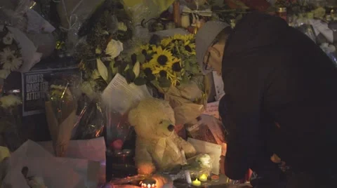 Paris terror attacks - Shrine, candle and teddy bear Stock Footage 57338982