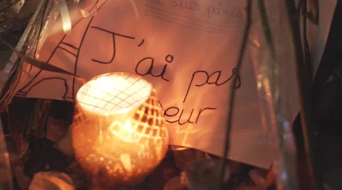Paris terror attacks - Shrine, candle and message Stock Footage 57339332