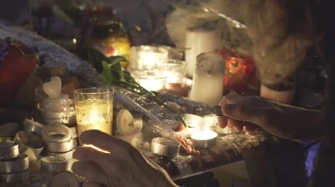 Paris terror attacks - Shrine / Lighting a candle close up Stock Footage 57338986