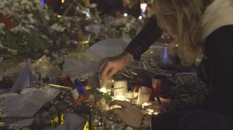 Paris terror attacks - Shrine / Lighting a candle Stock Footage 57339390