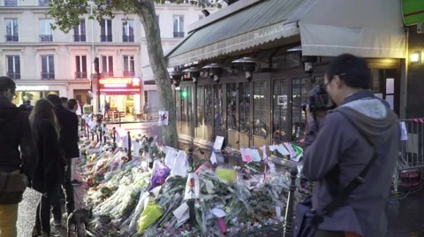 Paris terror attacks - Shrine / memorial in front cafe Stock Footage 57246051