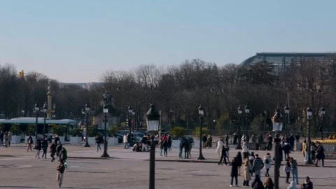 Paris traffic flows around the historic obelisk on a sunny day Stock Footage 321037108