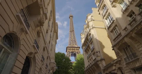 Paris view of the Eiffel Tower between the houses adjacent to it Stock Footage 250174013