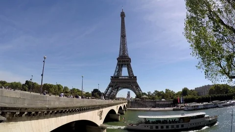 Paris wide shot static Eiffel Tower and Seine River boat passes under bridge Stock Footage 96217921